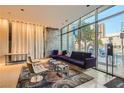 Contemporary lobby area with comfortable seating, stylish rugs, and floor to ceiling glass windows at 353 E Bonneville Ave # 904, Las Vegas, NV 89101