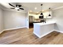 Modern kitchen with white cabinets, stainless steel appliances, granite countertops, and stylish lighting at 4050 Pacific Harbors Dr # 209, Las Vegas, NV 89121