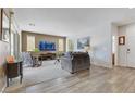 Bright living room with neutral tones, plush seating, and a large window with natural light at 410 Gracious Way, Henderson, NV 89011