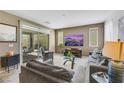 Comfortable living room with modern decor, plush seating, and sliding glass doors to outdoor area at 410 Gracious Way, Henderson, NV 89011