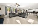 Expansive open-concept living room with tile floors flowing into the kitchen and dining area at 4148 Campriani Ave, North Las Vegas, NV 89084