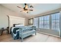 Bright bedroom featuring a large window, ceiling fan, and stylish decor at 4634 English Lavender Ave, North Las Vegas, NV 89031