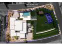 Aerial view of a custom estate on 1.07 acres featuring a pool, pickleball court, and lush landscaping at 505 Dragon Gate Ct, Henderson, NV 89012