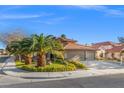 Beautiful single-Gathering home boasting a well-kept yard, green landscaping, and an attached spacious two-car garage at 5628 Crimson Ridge Dr, Las Vegas, NV 89130