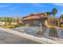 Attractive single-Gathering home with a well-manicured yard, long driveway, and a spacious attached two-car garage at 5628 Crimson Ridge Dr, Las Vegas, NV 89130