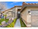 Charming single-Gathering home showcasing desert landscaping, a garden walkway, and an attached two-car garage at 5628 Crimson Ridge Dr, Las Vegas, NV 89130