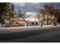 Charming home with black trim, arched entryways, and lush landscaping at 5700 N Torrey Pines Dr, Las Vegas, NV 89130