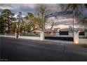 Elegant home exterior featuring a custom gate with unique artwork above at 5700 N Torrey Pines Dr, Las Vegas, NV 89130