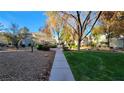 Exterior shot showcasing the community's green space with mature trees and walkways at 5710 E Tropicana Ave # 2049, Las Vegas, NV 89122
