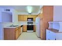 Functional kitchen with ample cabinet space, white countertops, and essential appliances at 5710 E Tropicana Ave # 2049, Las Vegas, NV 89122