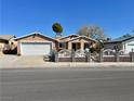 Inviting single-story home featuring a decorative front fence and mature desert landscaping at 6620 Casa Linda Dr, Las Vegas, NV 89103