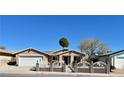 Inviting single-story home featuring a decorative front fence and mature desert landscaping at 6620 Casa Linda Dr, Las Vegas, NV 89103