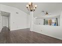 Bright living room with modern flooring, chandelier, and open view of the entry at 715 Rusty Spur Dr, Henderson, NV 89014
