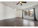 Inviting living room with stylish floors, large window, and access to front door at 715 Rusty Spur Dr, Henderson, NV 89014