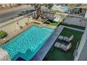 Aerial view of a private backyard featuring a sparkling in-ground swimming pool and patio furniture at 7420 Enchanted Hills Ct, Las Vegas, NV 89129