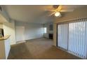 Living room with ceiling fan, fireplace, and sliding glass door for optimal light at 8250 N Grand Canyon Dr # 2085, Las Vegas, NV 89166