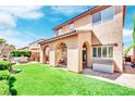 Spacious backyard with lush green grass, covered patio, and outdoor seating area perfect for entertaining at 952 Contadero Pl, Las Vegas, NV 89138