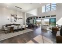Bright living space with soaring ceilings, a dining area, and seamless indoor-outdoor flow to the backyard at 10655 Patina Hills Ct, Las Vegas, NV 89135