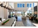 Sun-filled living area boasts high ceilings, modern lighting, and a fluid transition to outdoor living space at 10655 Patina Hills Ct, Las Vegas, NV 89135
