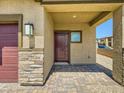 Close up view of the front door and stone facade at 10748 Wild Poppy Ave, Las Vegas, NV 89129