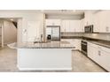 Bright kitchen with white cabinets, stainless steel appliances, and granite countertops at 10748 Wild Poppy Ave, Las Vegas, NV 89129