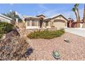 Charming home featuring a stone facade, two-car garage, and drought resistant landscaping at 1713 Diamond Oaks Ct, Las Vegas, NV 89117