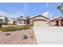 Charming home featuring a stone facade, two-car garage, and drought resistant landscaping at 1713 Diamond Oaks Ct, Las Vegas, NV 89117