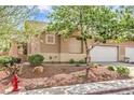 Charming single-story house with well-maintained landscaping, including desert rock and mature trees at 202 Twin Creek St, Henderson, NV 89074