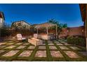 Relax in this backyard with a firepit, pavers and artificial turf at 2664 Ornate Regiment St, Henderson, NV 89044