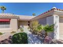 Home entrance showing well maintained landscaping and small patio area at 2739 Darby Falls Dr, Las Vegas, NV 89134