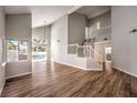 Spacious living room with a staircase and a view of the pool through large windows at 2916 Cape Verde Ln, Las Vegas, NV 89128