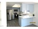 Bright kitchen featuring stainless steel appliances, white countertops and blue cabinets at 3484 Nightflower Ln # 2, Las Vegas, NV 89121
