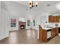 Bright living room features a brick fireplace, wood flooring, and a pass-through bar to the kitchen at 3609 Melonies Dr # 93, Las Vegas, NV 89103