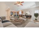 Bright, open-concept living room and kitchen area with stainless steel appliances and a large island with barstool seating at 4399 Luciano Ave, Pahrump, NV 89061