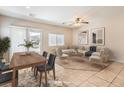 Comfortable living room and dining area with neutral furniture, tile floors, and a sliding door to the backyard at 4399 Luciano Ave, Pahrump, NV 89061