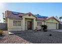 Inviting single-story home with solar panels, desert landscaping, and a two-car garage at 4405 Testarossa Ln, North Las Vegas, NV 89081