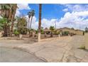 Spacious property with tall palm trees and a gated driveway at 4678 Saddle Pl, Las Vegas, NV 89119