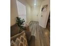 Bright entryway featuring wood-look floors, a window with blinds, and neutral decor at 5404 Walcott Dr, Las Vegas, NV 89118