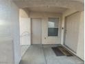 Inviting covered front porch with dual entry doors, a small window, and secure gate at 5404 Walcott Dr, Las Vegas, NV 89118