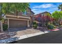 Beautiful two-story home features a two-car garage, lush trees, and a manicured lawn at 6148 Whitelion Walk St, Las Vegas, NV 89148