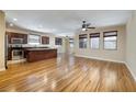 Spacious living room features hardwood floors, ceiling fan, modern lighting, and is virtually unstaged at 677 Viale Machiavelli Ln, Henderson, NV 89011