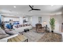 Spacious living room featuring hardwood floors, modern ceiling fan, and ample natural light at 6773 Bristle Falls St, Las Vegas, NV 89149