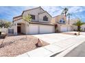 Two-story home with a two-car garage, desert landscaping, and a welcoming covered entryway at 80 Sea Holly Way, Henderson, NV 89074
