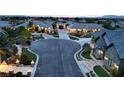 An aerial view shows the neighborhood with lush landscaping, street lights, and well maintained sidewalks at 8369 Eagle Estates Ct, Las Vegas, NV 89131