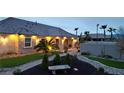 Charming home featuring meticulous landscaping, beautiful stone accents, and inviting outdoor lighting at 8369 Eagle Estates Ct, Las Vegas, NV 89131