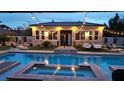 Inviting backyard featuring a sparkling pool, hot tub, string lights, and outdoor seating at 8369 Eagle Estates Ct, Las Vegas, NV 89131