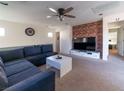 Open living room with exposed brick wall and comfortable seating at 9105 Captivating Ave, Las Vegas, NV 89149