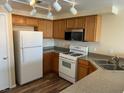 Traditional kitchen with wood cabinets, gas range, stainless steel microwave, and durable countertops at 9303 Gilcrease Ave # 2164, Las Vegas, NV 89149
