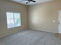 Bright living room with neutral walls, carpet, and natural light from a large window at 9303 Gilcrease Ave # 2164, Las Vegas, NV 89149