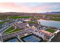 Scenic aerial view of a Primary-planned community with a pond, tennis courts, and green spaces at , Las Vegas, NV 89108